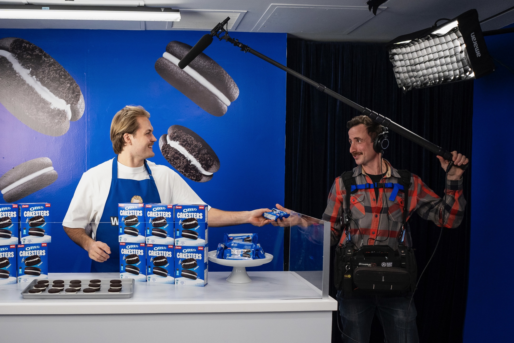 Adam White and a boom operator recording location sound on a film set